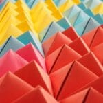Kolorowe papierowe piramidki ułożone w geometryczny wzór